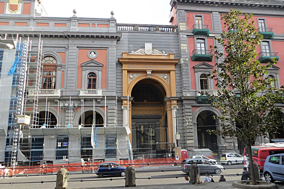 The arched entrance of the Galleria Principe di Napoli on Piazza Museo, with the gallery's name over the arch